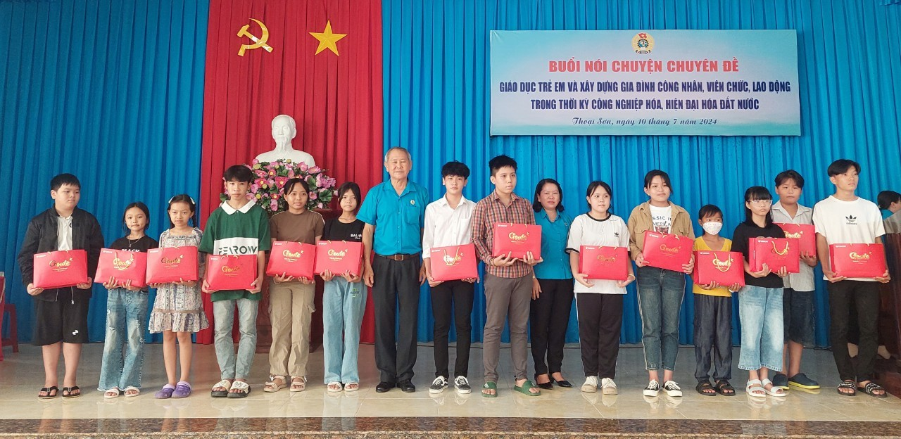 A group of people holding red papers
Description automatically generated