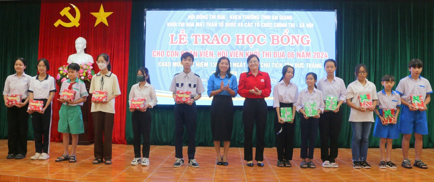 A group of people standing on a stage
Description automatically generated