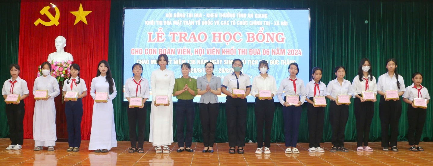 A group of people standing on a stage
Description automatically generated